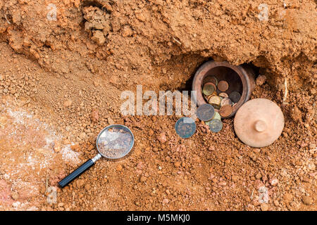 Coin in the jar.The concept of discovering treasures from underground. Stock Photo