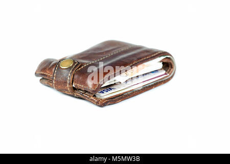Isolated brown leather wallet containing British currency and credit card on white background Stock Photo