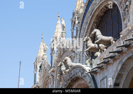 Venice, Veneto, Italy. Detail of the bronze horses on the facade of Basilica San Marco in Piazzo San Marco viewed from below. These horses are replica Stock Photo