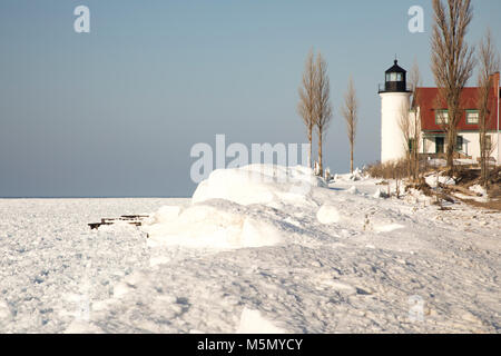 Exterior of historic Point Betsie Lighthouse on frozen Lake Michigan in winter. Stock Photo