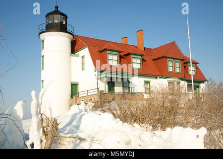 Exterior of historic Point Betsie Lighthouse on frozen Lake Michigan in winter. Stock Photo