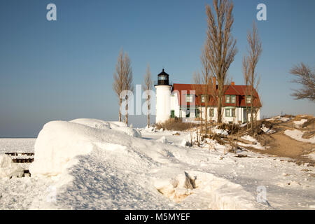 Exterior of historic Point Betsie Lighthouse on frozen Lake Michigan in winter. Stock Photo