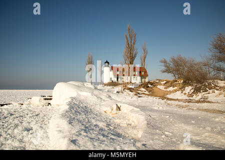 Exterior of historic Point Betsie Lighthouse on frozen Lake Michigan in winter. Stock Photo