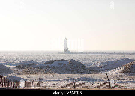 Frankfort North Breakwater historic lighthouse in fog on shores of Lake Michigan in winter. Stock Photo