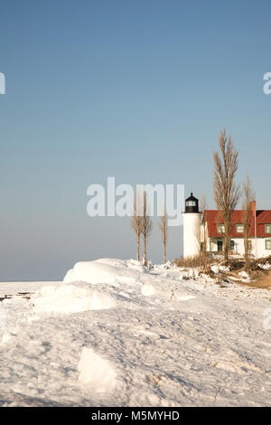 Exterior of historic Point Betsie Lighthouse on frozen Lake Michigan in winter. Stock Photo