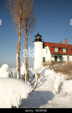 Exterior of historic Point Betsie Lighthouse on frozen Lake Michigan in winter. Stock Photo