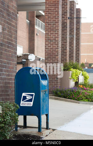 A United States Postal Service blue mailbox in USA America. Stock Photo