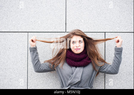 teenager brunette girl pulling her hair Stock Photo
