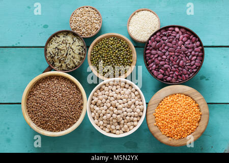 various cereals (beans, lentils, rice, kinoa) in wooden bowls Stock Photo