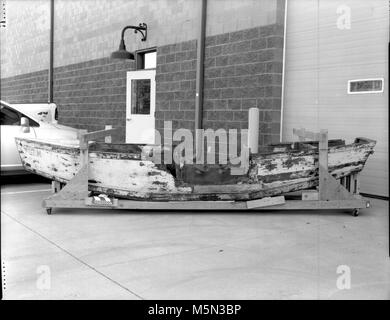 GRCA  Grand Canyon Historical Boat CollectionGem Boat . Catalog # GRCA 32095  Object BOAT  Description  BOAT WITH WHITE EXTERIOR, TAPERED BOW AND SQUARE STERN. HAS 8 COMPARTMENTS,  TWO OF WHICH WERE FILLED WITH PLASTIC BOTTLES, FOR FLOTATION. MOST OF THE TOP  DECKING OF THE BOAT IS MISSING. THE BOW IS MARKED ’GEM’ IN BLUE ON BOTH SIDES.  BROWN WOODEN INTERIOR. THE COMPARTMENT WALLS ARE BROKEN, THE SIDES HAVE  PIECES MISSING, AND THE WOOD IS CRACKE Stock Photo