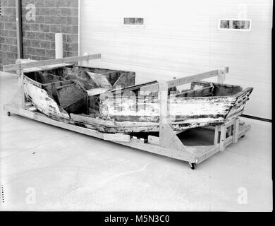 GRCA Grand Canyon Historical Boat Collection Gem Boat . Catalog # GRCA 32095  Object BOAT  Description  BOAT WITH WHITE EXTERIOR, TAPERED BOW AND SQUARE STERN. HAS 8 COMPARTMENTS,  TWO OF WHICH WERE FILLED WITH PLASTIC BOTTLES, FOR FLOTATION. MOST OF THE TOP  DECKING OF THE BOAT IS MISSING. THE BOW IS MARKED ’GEM’ IN BLUE ON BOTH SIDES.  BROWN WOODEN INTERIOR. THE COMPARTMENT WALLS ARE BROKEN, THE SIDES HAVE  PIECES MISSING, AND THE WOOD IS CRACKE Stock Photo