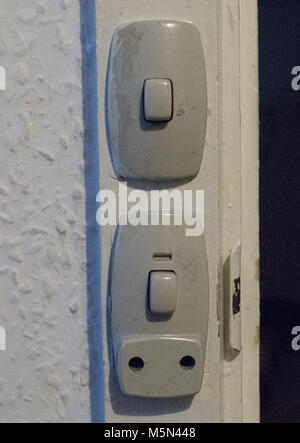 Grey old danish power socket in a wooden door frame Stock Photo
