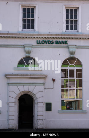 A high street branch of Lloyd’s bank in a converted Victorian building with a grand entrance and Victorian sash windows. Banking and town centre road. Stock Photo