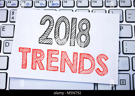 Handwritten text caption showing 2018 Trends. Business concept writing for Trending Data Prediction written on sticky note paper on white keyboard bac Stock Photo