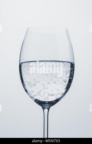 poured mineral water in wine glass, closeup Stock Photo