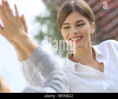 members of the business team giving each other a high five. Stock Photo