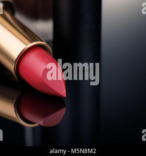 Fashion Colorful Lipsticks over black background with space for text. Lipstick tints palette, Professional Makeup and Beauty, closeup Stock Photo