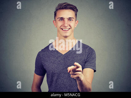 Portrait of a happy young man pointing his finger at you Stock Photo