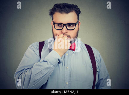 Portrait of a preoccupied anxious young man looking down Stock Photo