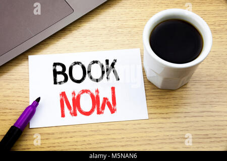 Handwriting Announcement text showing Book Now. Business concept for Reservation Buy Booking written on notebook book on wooden background in the Offi Stock Photo