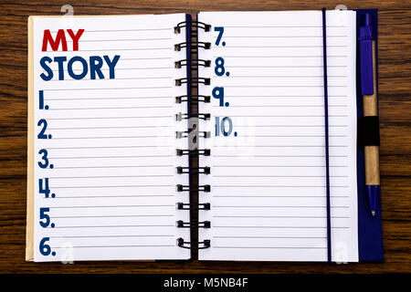 Writing text showing My Story. Business concept for Telling Tell About You Written on notebook paper, wooden background with pen and marker. Stock Photo