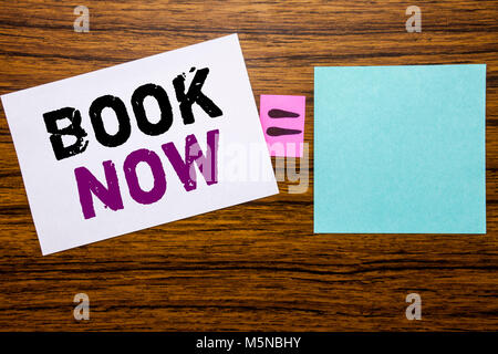 Handwriting Announcement text showing Book Now. Business concept for Reservation Buy Booking written on sticky note paper wooden background. Equation  Stock Photo