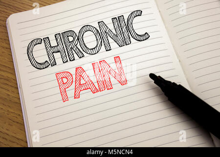 Handwriting Announcement text showing Chronic Pain. Business concept for Feeling Bad ill Care written on notebook with space on book background with m Stock Photo