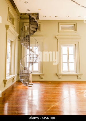 Iron Metal Spiral Staircase in a Corner of a Room Stock Photo