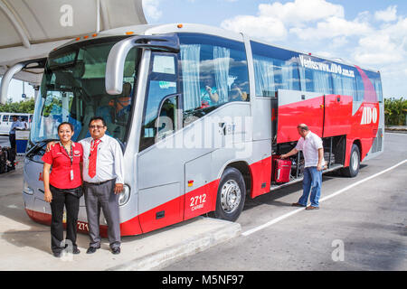 Cancun Mexico,Mexican,Cancun International Airport,Hispanic woman female women,ADO bus,coach,ground transportation,ticket agent,driver,luggage,suitcas Stock Photo