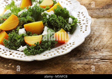 Fresh golden beet salad with fresh kale lettuce, feta cheese on wooden background Stock Photo