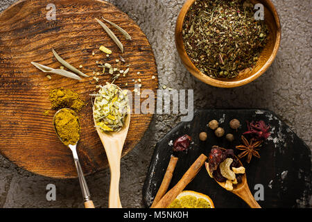 Different dry spices on textured wooden boards. View from top Stock Photo