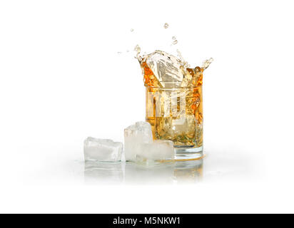 Glass of splashing whiskey near ice cubes isolated on white with clipping path Stock Photo