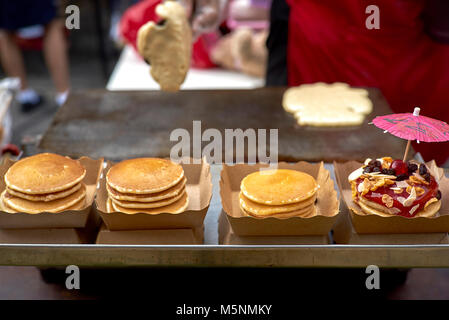 Thailand street food vendor preparing and decorating filled pancakes. Derived from American style pancakes. 1 of 4 Stock Photo
