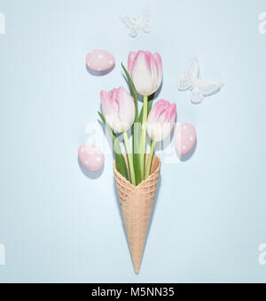 Tulip flowers in the waffle cone with easter eggs Stock Photo