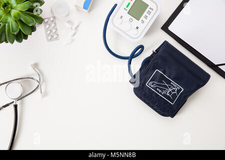 Blood Pressure Machine With Stethoscope And Clipboard On White T