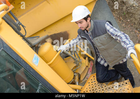 worker climbing on an equipment Stock Photo