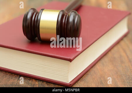 Wooden Gavel on top of a law book in court Stock Photo