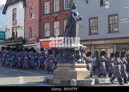 Cold stream guards marching past the statue of Queen Victoria near  Windsor castle Stock Photo