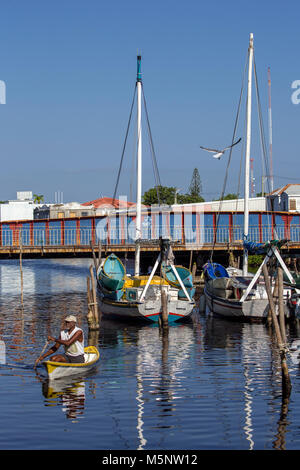 Man paddling in Haulover Creek at the Belize City Swing Bridge Stock Photo