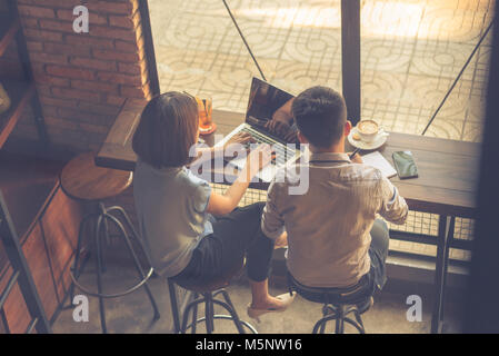 Young Asian freelancers working on laptop Stock Photo