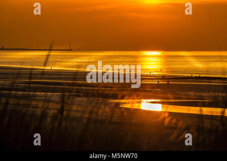 Sunset view from top of dunes towards the sea Stock Photo