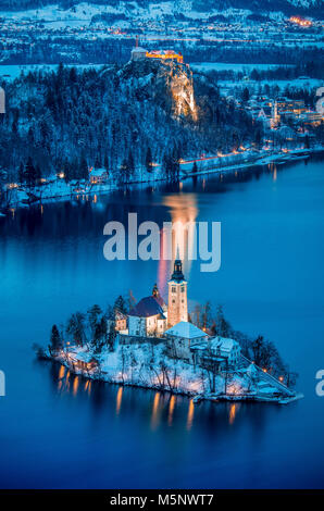 Beautiful aerial twilight view of Lake Bled with famous Bled Island and historic Bled Castle in the background during scenic blue hour at dawn in wint Stock Photo