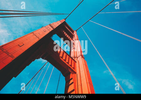 Beautiful low angle view of famous Golden Gate Bridge with blue sky and clouds on a sunny day in summer with retro vintage post crocessing filter effe Stock Photo