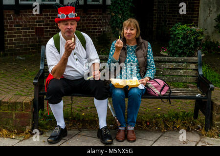 A Couple Eating Fish and Chips During The Annual Lewes Folk Festival, Lewes, Sussex, UK Stock Photo