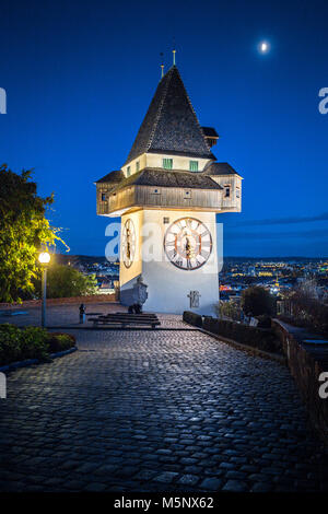 Beautiful twilight view of famous Grazer Uhrturm (clock tower) illuminated during blue hour at dusk, Graz, Styria region, Austria Stock Photo