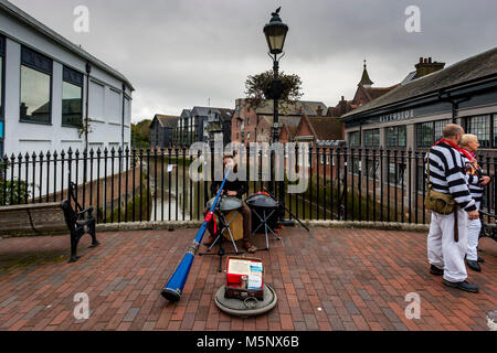 A Man Playing A Didgeridoo In The High Street, Lewes, Sussex, UK Stock Photo