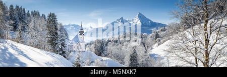 Panoramic view of beautiful winter landscape in the Bavarian Alps with pilgrimage church of Maria Gern and famous Watzmann in winter, Bavaria, Germany Stock Photo