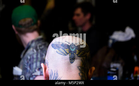 Brighton UK 25th February 2018 - Tattooists at work at the 11th annual Brighton Tattoo Convention held in the Brighton Centre over the weekend attracting tattoo artists from all over the world Photograph taken by Simon Dack Credit: Simon Dack/Alamy Live News Stock Photo