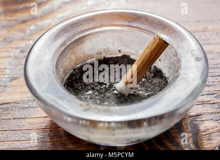 cigarette with ashtray on wood table . Stock Photo