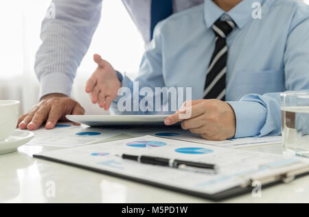 Marketing staff are analyzing the data to business planning. Stock Photo